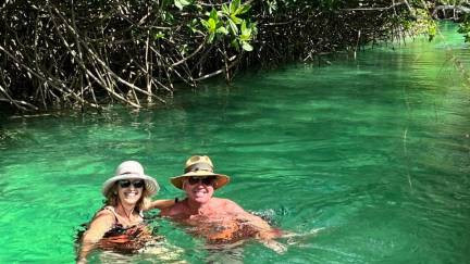 Couple swimming inside the Sian Ka'an lazy river channel