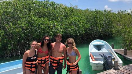 Tour group wearing life vests in front of the Sian Ka'an river