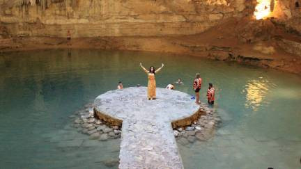 Woman standing in rock path in the middle of a cenote