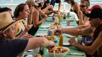 Group tour enjoying a Mexican meal at the beach