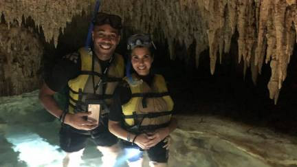 Visitors exploring a cave cenote