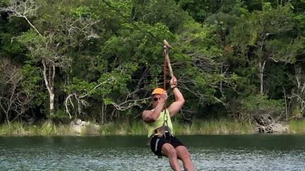 Zip lining over the crystalline water of a cenote