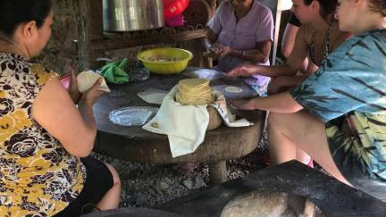 Visitors learning how to make tortillas the traditional Mexican way