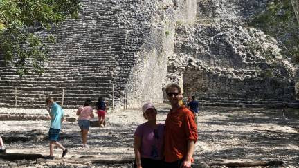 Visitors standing in front of an archeological site